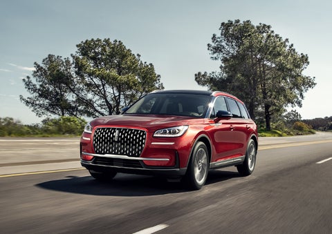 A 2024 Lincoln Corsair® SUV is shown being driven on a country road. | Lincoln of Cutler Bay in Miami FL
