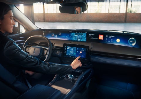 The driver of a 2024 Lincoln Nautilus® SUV interacts with the center touchscreen. | Lincoln of Cutler Bay in Miami FL