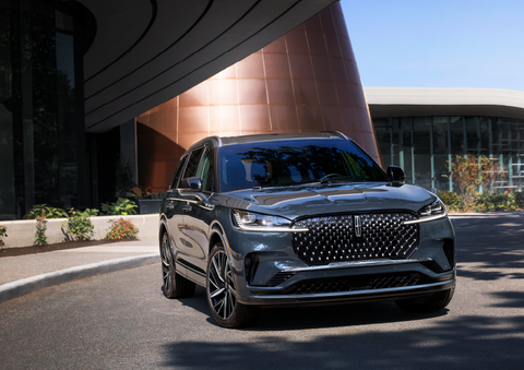 A gray 2025 Lincoln Aviator® SUV is parked outside a modern building with the sun shining. | Lincoln of Cutler Bay in Miami FL