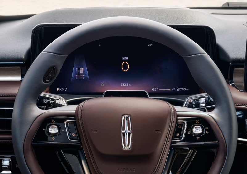 The steering wheel of 2025 Lincoln Aviator® SUV is shown with black and brown accents. | Lincoln of Cutler Bay in Miami FL