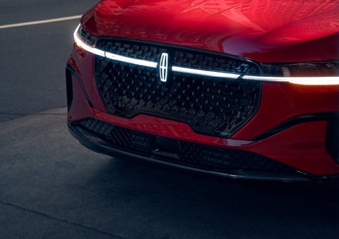 The available front LED light bar and center Lincoln Star logo glow at dusk. | Lincoln of Cutler Bay in Miami FL